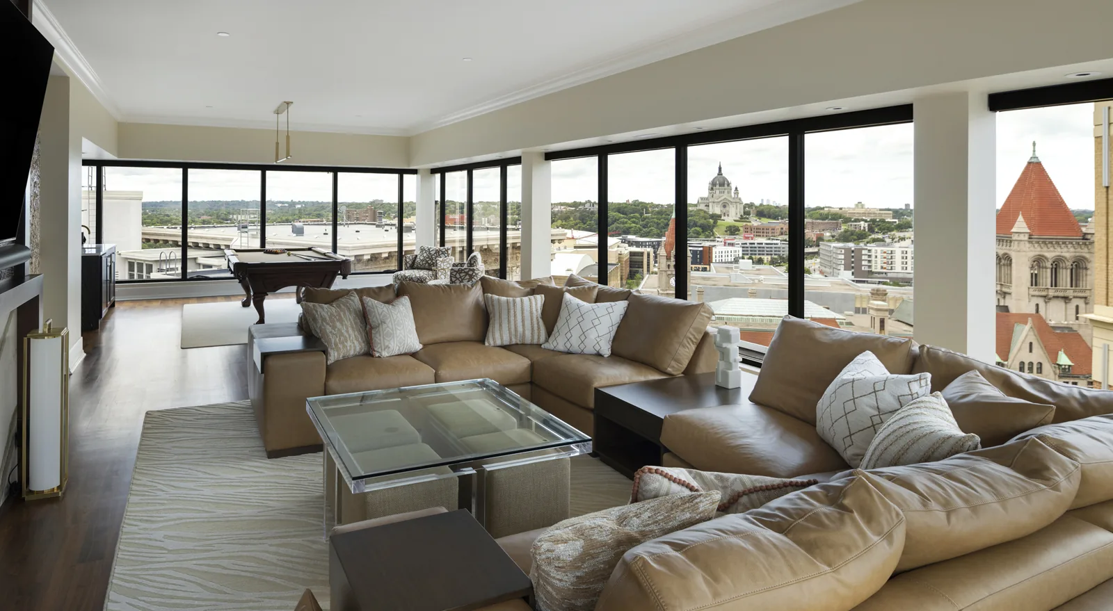Living room with a marble fireplace, layered seating and panoramic Saint Paul views